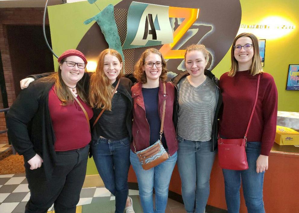 Five white women standing in front of the American Jazz Museum sign and smiling